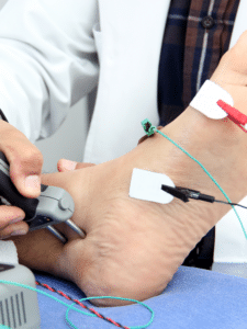 doctor performing emg test and ncs nerve conduction study